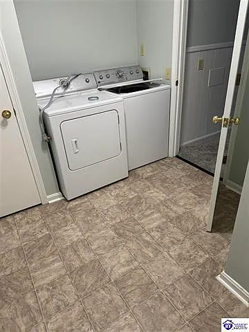 Laundry room with outside entry door, closet and separate shower. Washer and dryer.