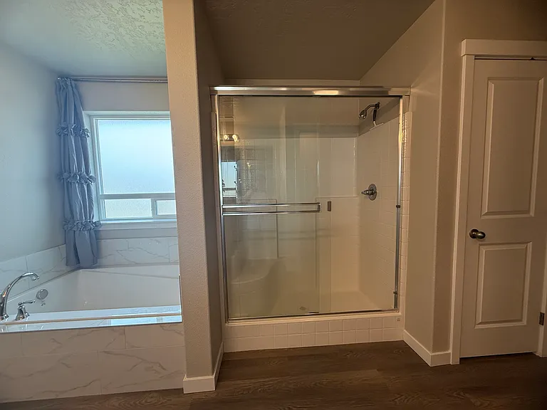 Large glass walk-in shower in the primary bathroom.