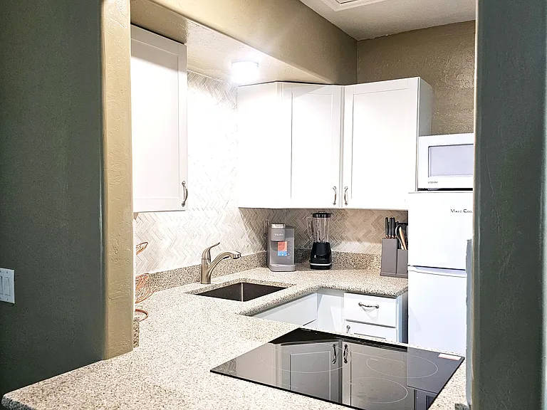 The kitchenette has a nice size fridge, microwave, dishes and induction stove.