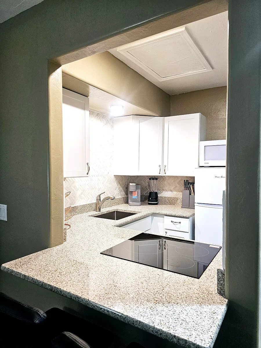 The kitchenette has a nice size fridge, microwave, dishes and induction stove. - 2269-2299 Coronado Dr