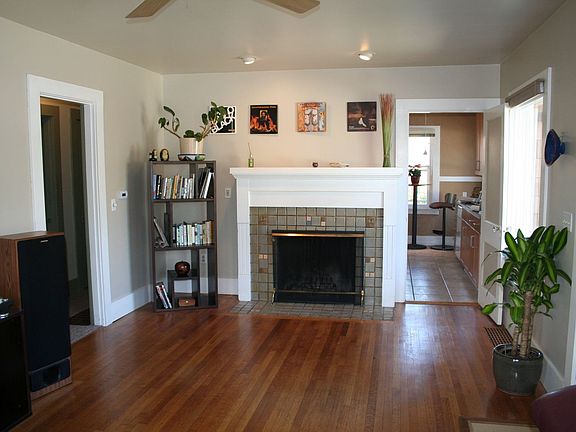 Distinctive tile work on the fireplace and lovely hardwoods thru living area.