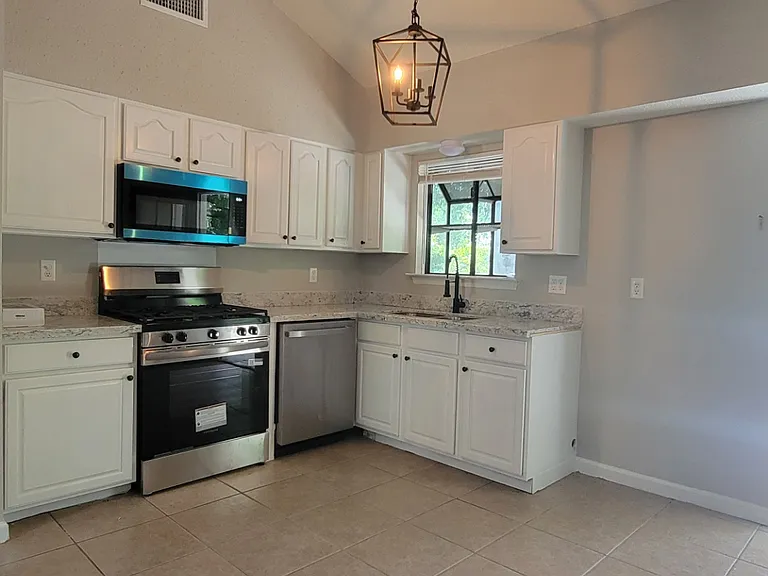 Newly Renovated Kitchen with Granite Countertops and New Stainless Steel Appliances