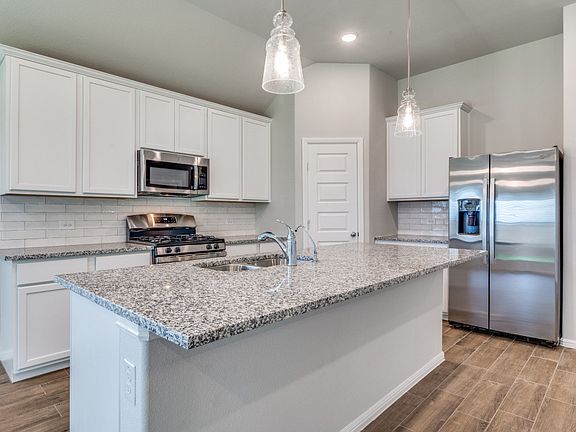 Kitchen includes gas range, dishwasher, microwave and refrigerator