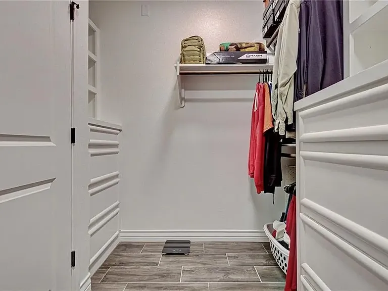 Primary walk-in closet offering plenty of room for clothing, shoes, and additional storage.