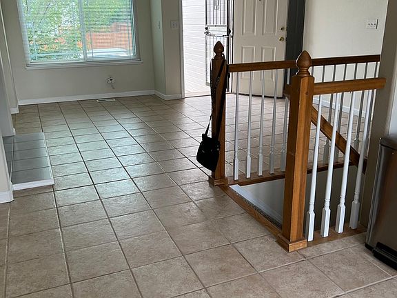 Front door and small living room as seen from dining area.