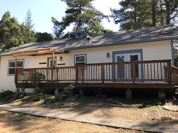 back of house with deck