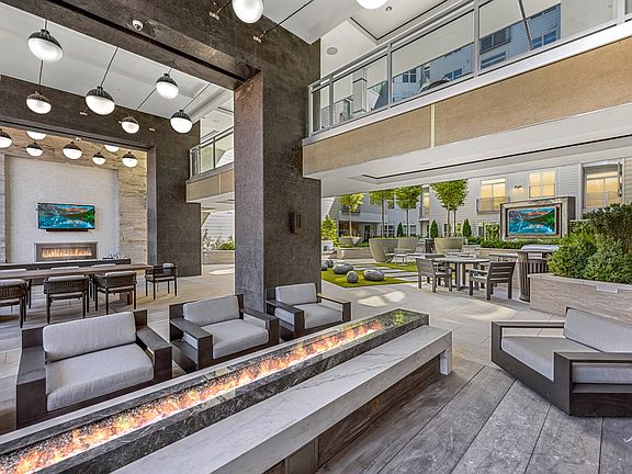 Loggia with cozy lounge seating areas, TV and fireplace