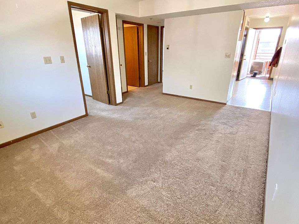 Living room photo 1. Entrance shown on right side. First bedroom, bathroom, and storage closet shown on left side. Second bedroom is farther down hallway