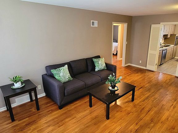 Furnished living Room Area leading into Kitchen Area