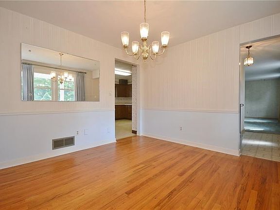 Dining room is complemented with beautiful original hardwood floors while the chair rail adds a nice touch to the walls.