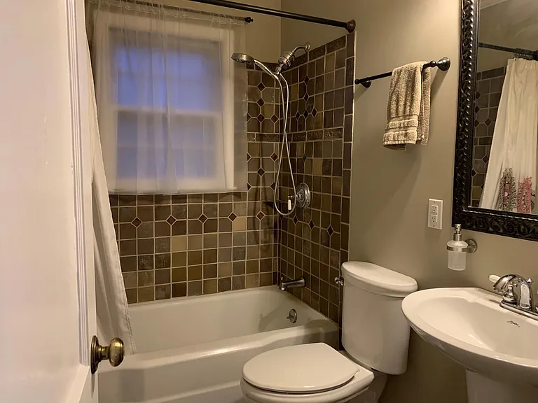 Upstairs bathroom hand made tiles shower over tub