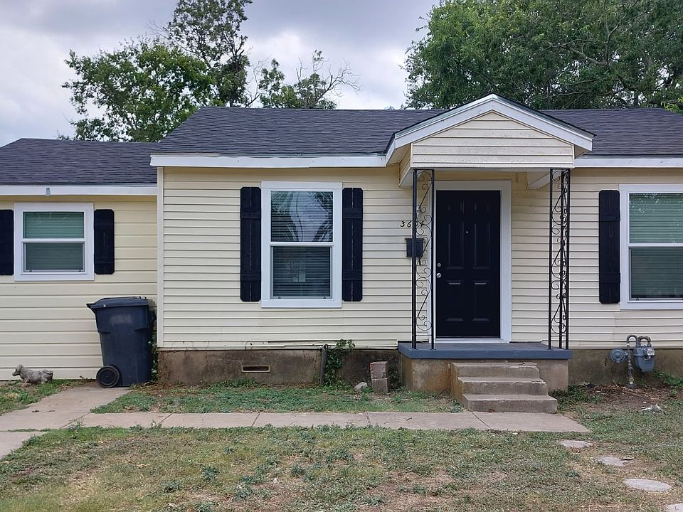 Cozy front of home yellow siding with black trim