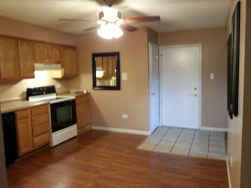 Entry to condo is to the kitchen, with a 5 foot entry to the living room. Entry door is white door on the right. To the left of the entry door is a coat CLOSET. Ceramic tile floor at entry. Kitchen has laminate wood flooring, newer cabinets/counters,