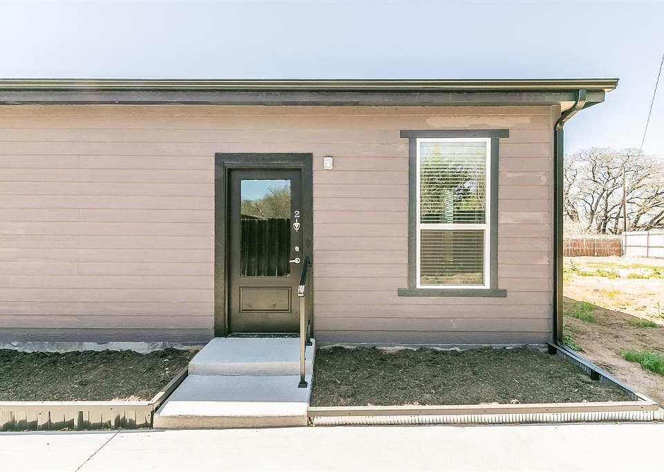 View of exterior entry featuring fence
