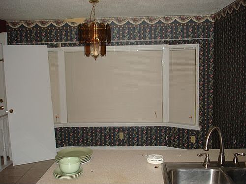 Large open kitchen with eat-in area by bay window