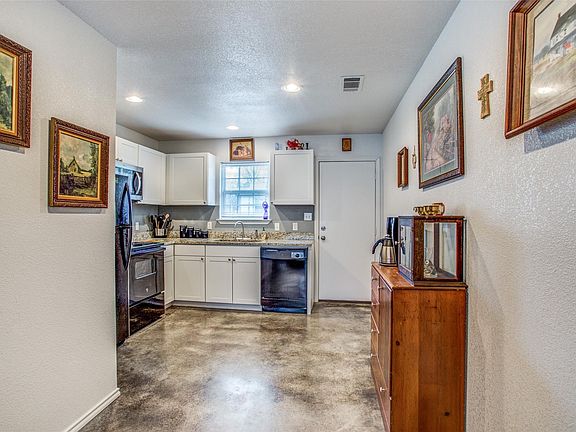 Kitchen with garbage disposal, Dishwasher, electric range, microwave, granite counters, and refrigerator