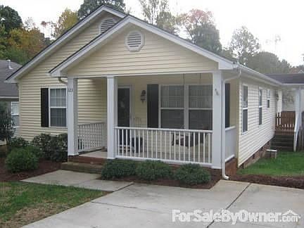 Front of home with swing on porch