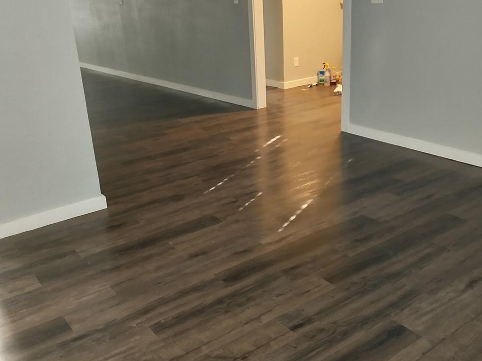 Living room sunlight streaking through the shades on the floor.