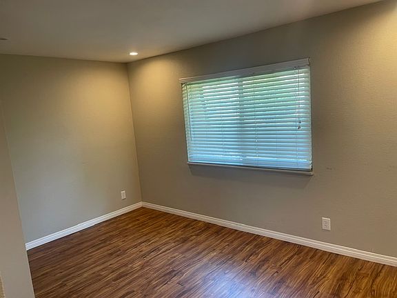 Bright and versatile second bedroom. Perfect for guests, home office, or family. (entry view)