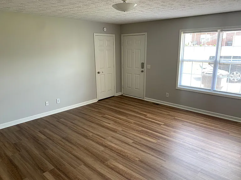 Large living room with picture window and front closet