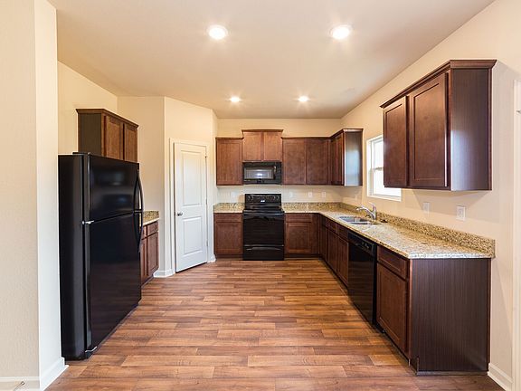 Gorgeous upper-wood cabinets with crown molding provide plenty of storage space