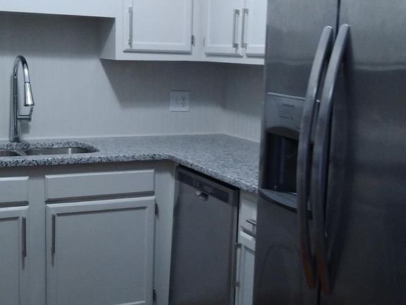 Granite countertops, stainless steel appliances, cabinet hardware. Beautiful hardwood floors in kitchen