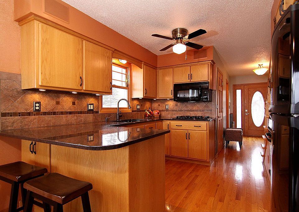 Indian copper granite counters, custom cabinets, hardwood floors, pantry
