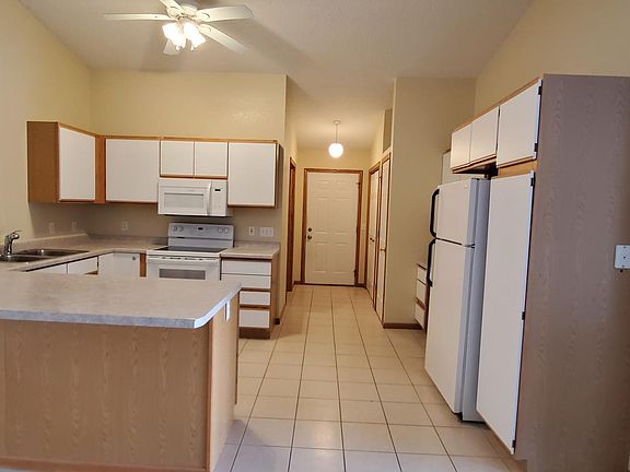 Kitchen has built-in desk area, dishwasher, and pantry closet