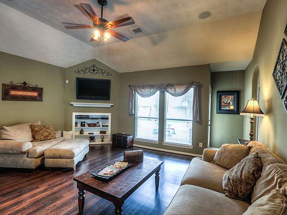 Spacious Living Area, Neutral Tones, Wood Laminate Flooring, Corner Entertainment Area