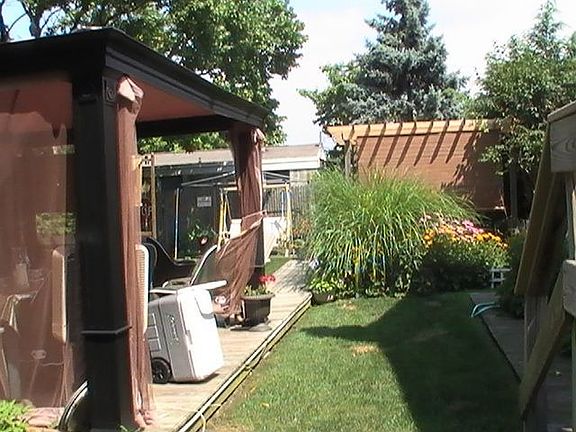 Large side yard with deck and canopy