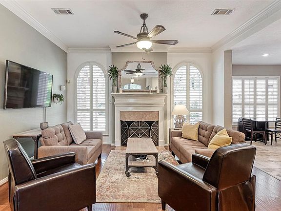 This Family Room with a center fireplace and custom mantel provides a relaxing place to visit with friends and family or watch TV