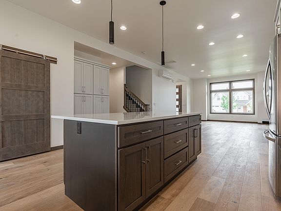 Open concept, large kitchen, an abundance of cabinets, stainless appliances, flex room off kitchen w/ barn door finish