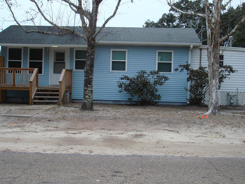The front of the house with new fence and porch