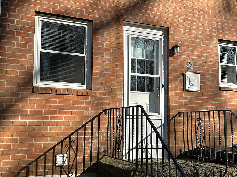 Private rear entrance overlooks wooded backyard.