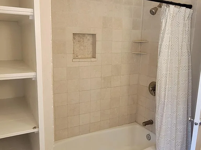 Main floor bathroom. Beautiful tile with built in shelving.