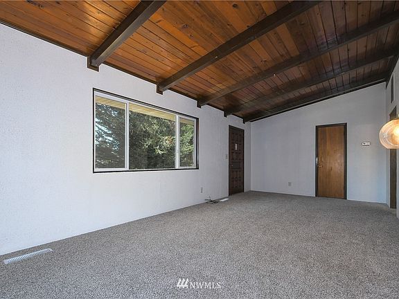 Living room with vaulted open beamed ceilings 