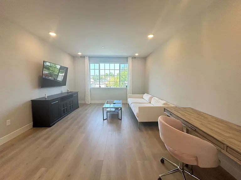 Light filled living room with high ceilings