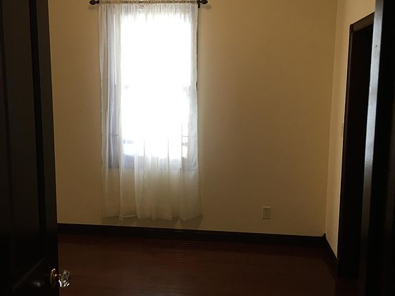 2nd BR (10' x 11') Entry with Walk In Closet Entry to Right with Pocket Door - Roller Shades & Drapes provided