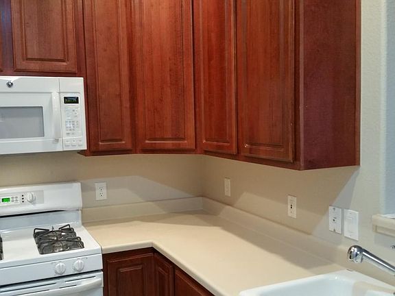 Lots of counter space with gas range - picture granite with stainless under mount double sink and bar sprayer fixture