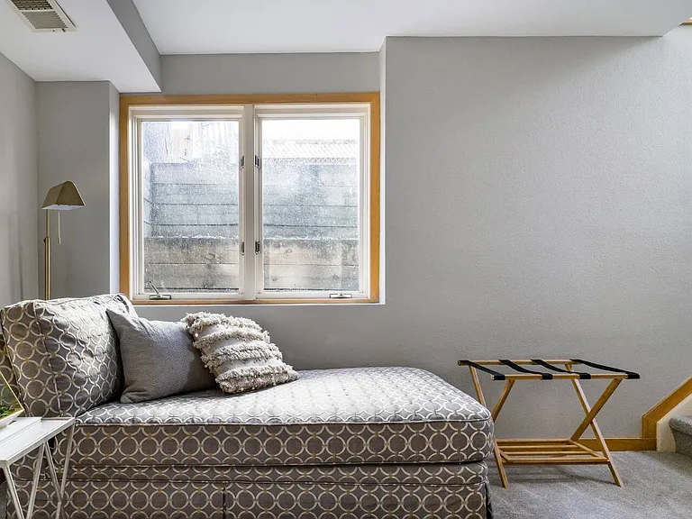 Lounge area in South East Basement bedroom, stairs lead to side privacy entrance.