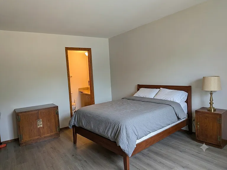 Another view of the main bedroom showing the half bath and virtual furniture