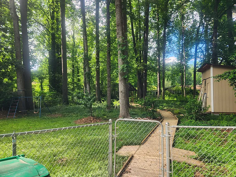Storage shed and walkway to gazebo in backyard