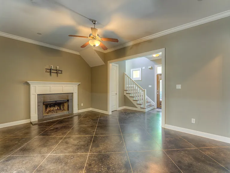 Living room looking towards foyer and fireplace.