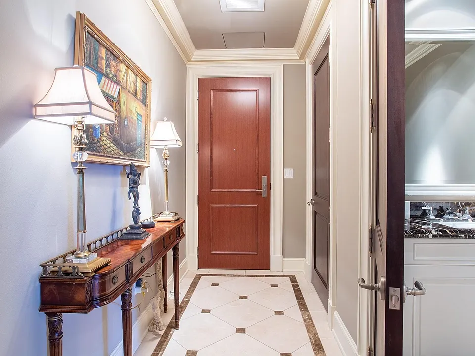Inlaid marble entry with powder room.
