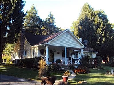 Rear of home. Nice sized back porch that is the spot for morning coffee and to watch wildlife. Dog does not come with the home. His name is Gus and he is super friendly.