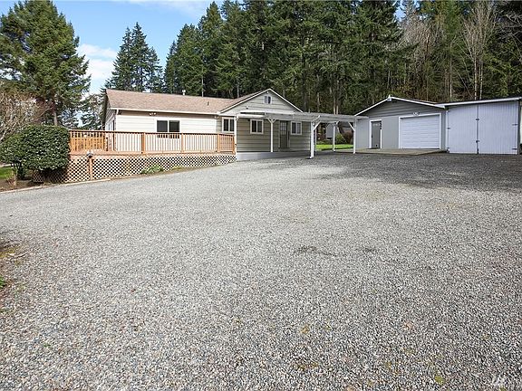 It has an a three car detached garage with an attached carport, providing lots of room to park vehicles.