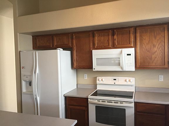 Newer smooth top range, microwave and side by side refrigerator.