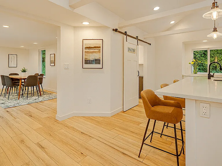 Stylish and functional: enjoy meals at the island bar or gather around the dining table just steps away_perfect for both casual mornings and cozy dinners