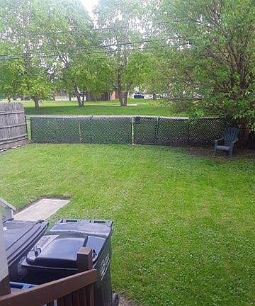 rear yard view when standing on your back porch. City park and library on the other side of your fence