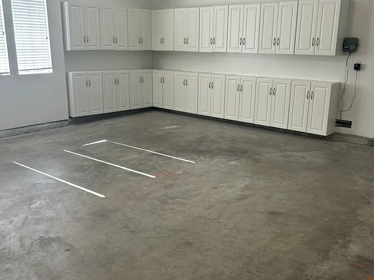Garage with lots of storage cabinets, freshly painted